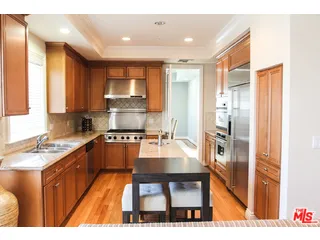 a kitchen with refrigerator cabinets and a sink