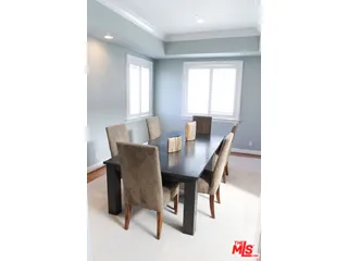 a view of a dining room with furniture and a window