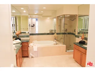 a bathroom with a tub sink and mirror