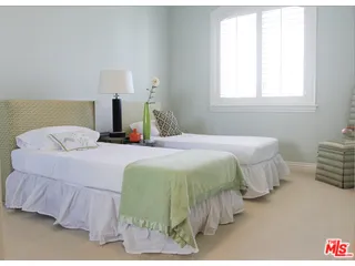 a bedroom with a bed and a night stand