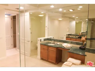 a bathroom with a sink a toilet and a mirror