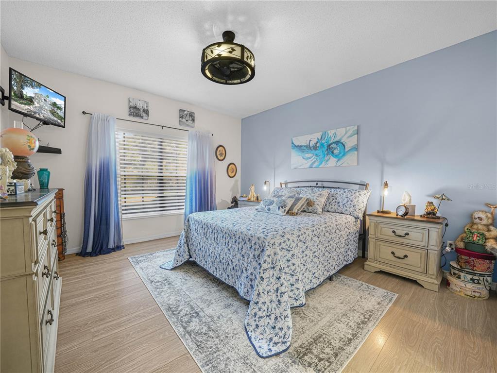 414 Eagle Ridge Drive, Unit 414 Davenport, FL 33837 - Photo 14 of 28 a bedroom with a bed and a chandelier