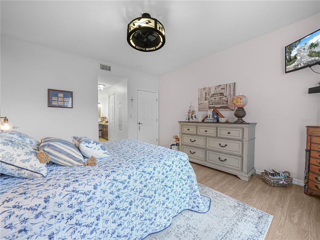 414 Eagle Ridge Drive, Unit 414 Davenport, FL 33837 - Photo 15 of 28 a bedroom with a bed and cabinets