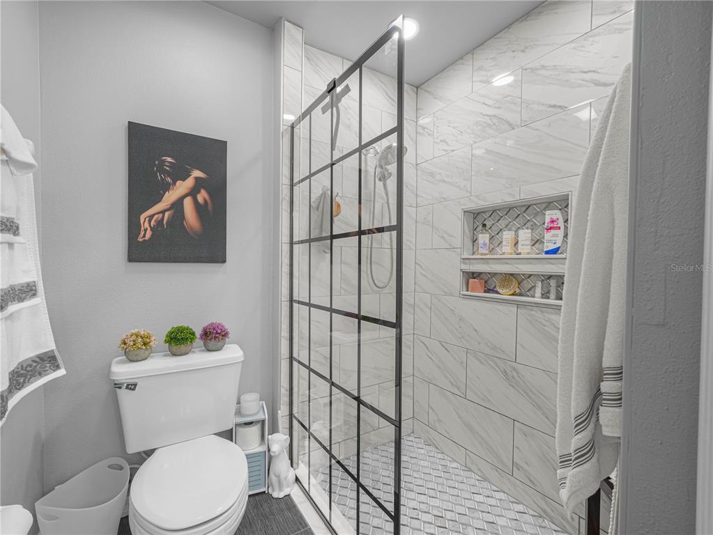 414 Eagle Ridge Drive, Unit 414 Davenport, FL 33837 - Photo 17 of 28 a white toilet sitting next to a bathroom sink