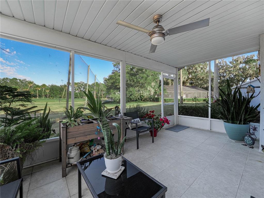 414 Eagle Ridge Drive, Unit 414 Davenport, FL 33837 - Photo 18 of 28 a living room with patio furniture and garden view