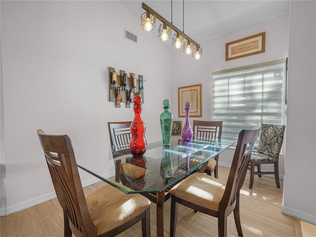 414 Eagle Ridge Drive, Unit 414 Davenport, FL 33837 - Photo 4 of 28 a view of a dining room with furniture