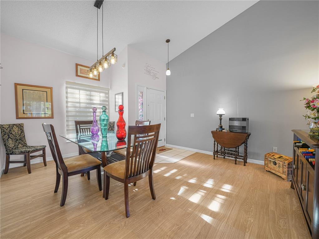 414 Eagle Ridge Drive, Unit 414 Davenport, FL 33837 - Photo 5 of 28 a view of a dining room with furniture window and wooden floor