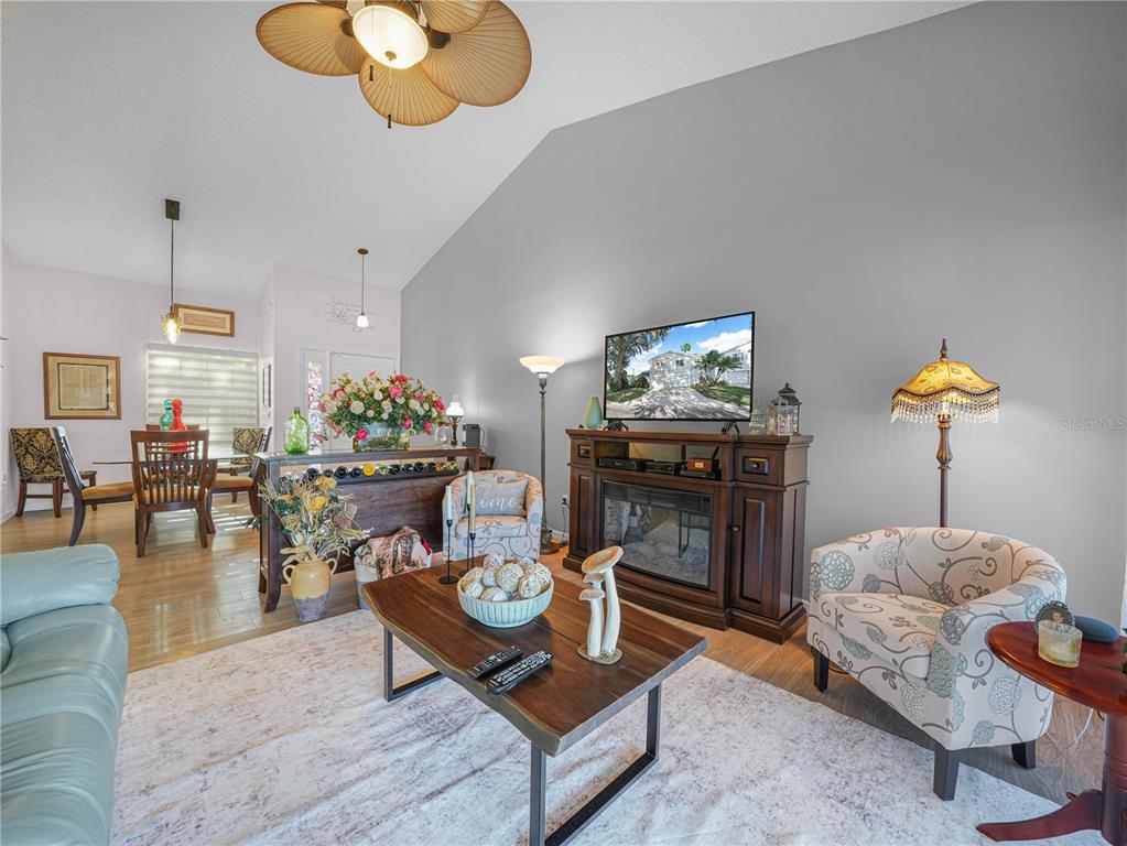 414 Eagle Ridge Drive, Unit 414 Davenport, FL 33837 - Photo 7 of 28 a living room with furniture and a chandelier
