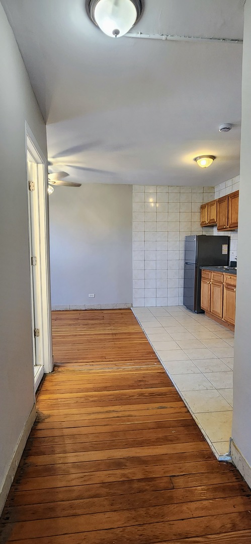 4764 North Virginia Avenue, Unit 206 Chicago, IL 60625 - Photo 6 of 16 a view of empty room with wooden floor