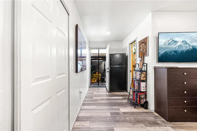 a view of a hallway with closet and cabinet