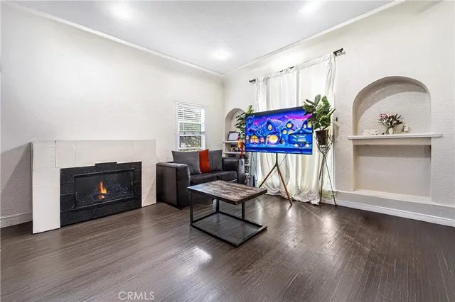 a living room with furniture a fireplace and wooden floor
