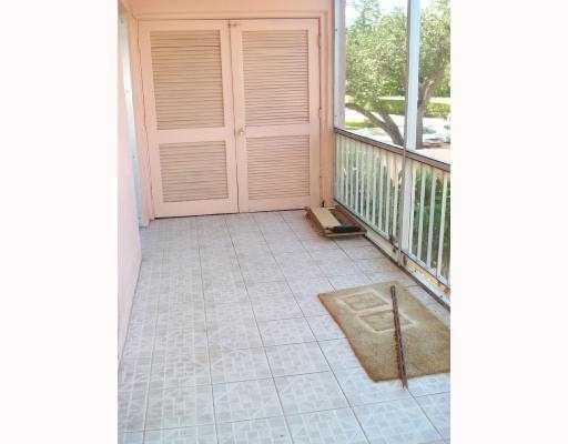 608 Northwest 13th Street, Unit 28 Boca Raton, FL 33486 - Photo 5 of 14 a view of a small space with racks on the wall