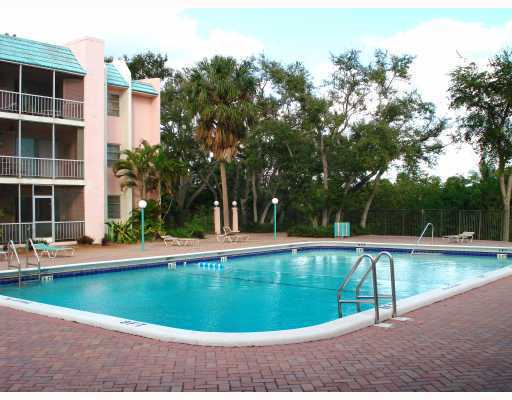 608 Northwest 13th Street, Unit 28 Boca Raton, FL 33486 - Photo 8 of 14 a view of a swimming pool with a sitting area