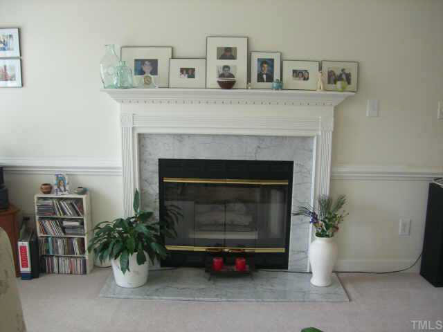 3823 Cambridge Road Durham, NC 27705 - Photo 4 of 8 This beautiful fireplace with marble and mouldings creates a formal feeling in the living room