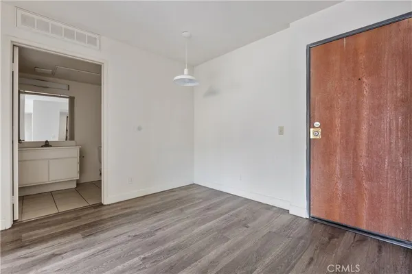 a view of an empty room and wooden floor