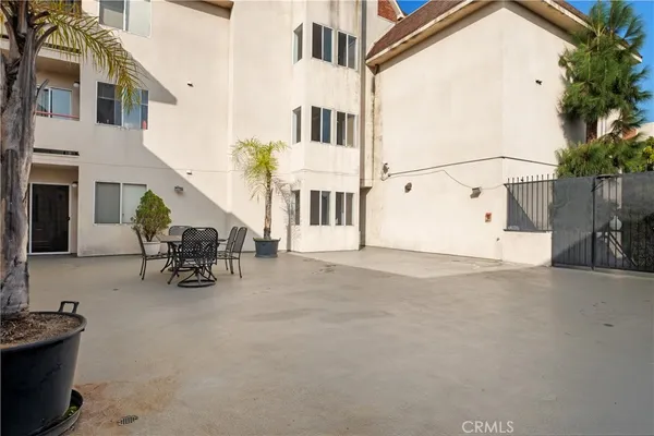 a view of a patio with table and chairs and potted plants