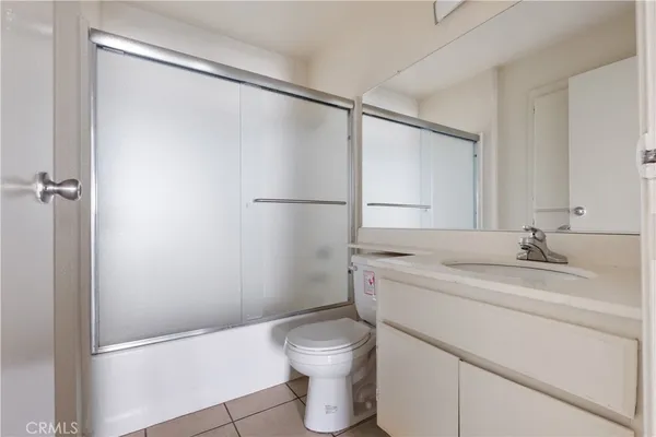 a bathroom with a granite countertop sink toilet and a shower