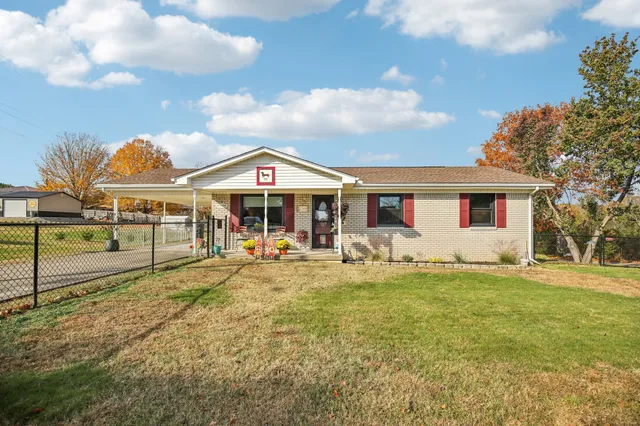 a front view of a house with swimming pool and porch with furniture