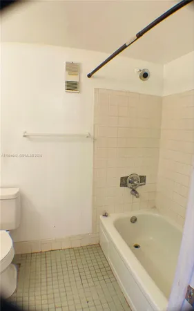 a bathroom with a bathtub and toilet