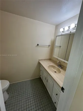 a bathroom with a sink a toilet and mirror