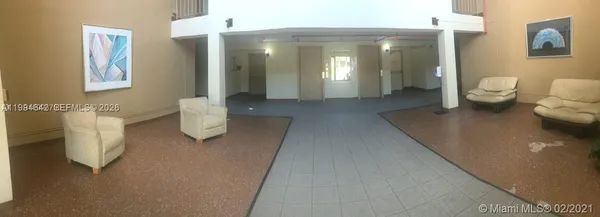 a living room with furniture and a toilet