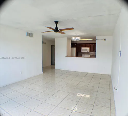 a view of an empty room with a fireplace