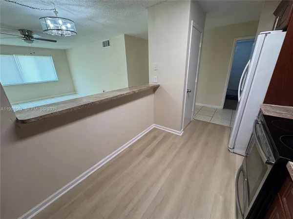 a view of a room with wooden floor and staircase