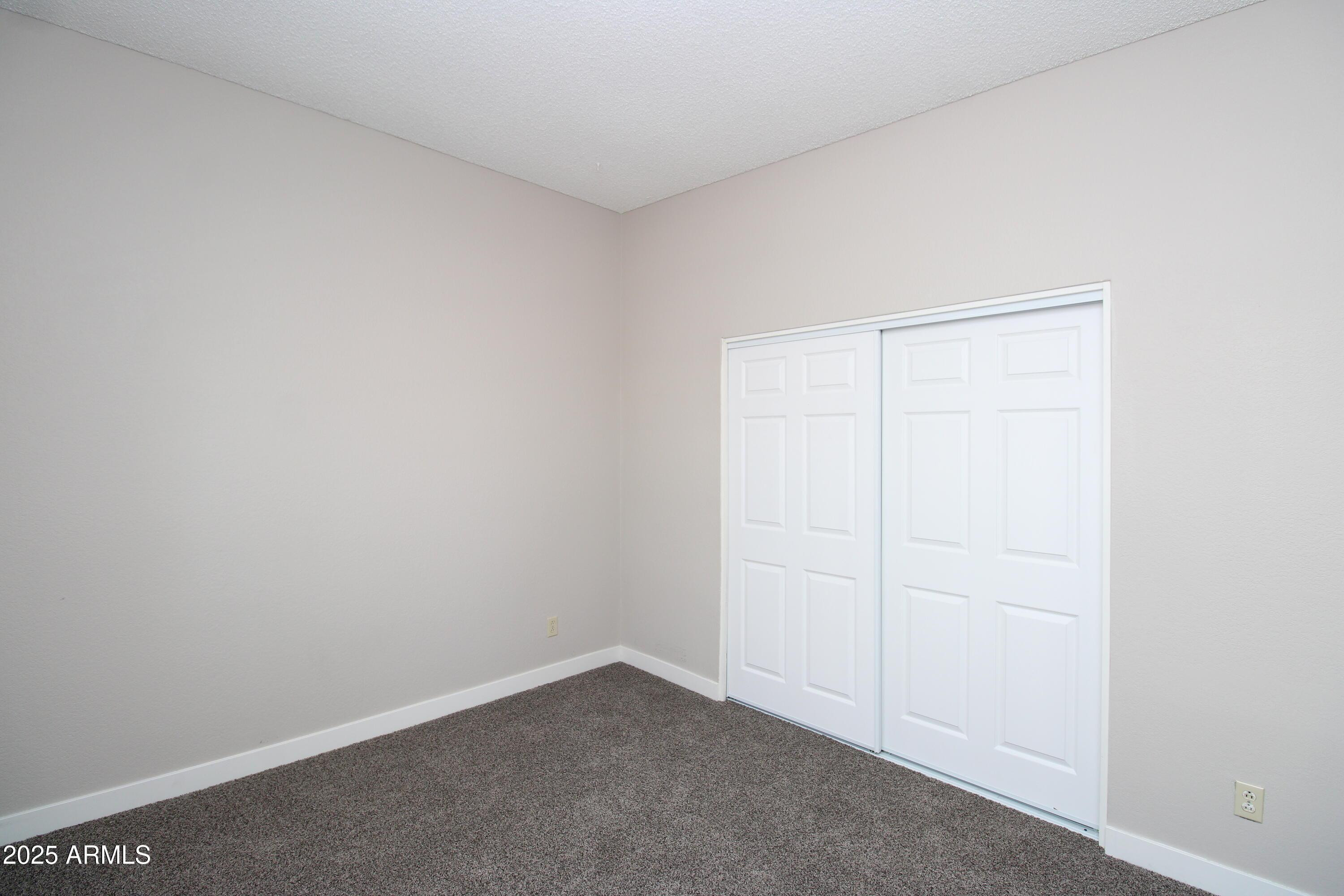 2807 East Paradise Lane, Unit 102 Phoenix, AZ 85032 - Photo 9 of 12 an empty room with a workbench