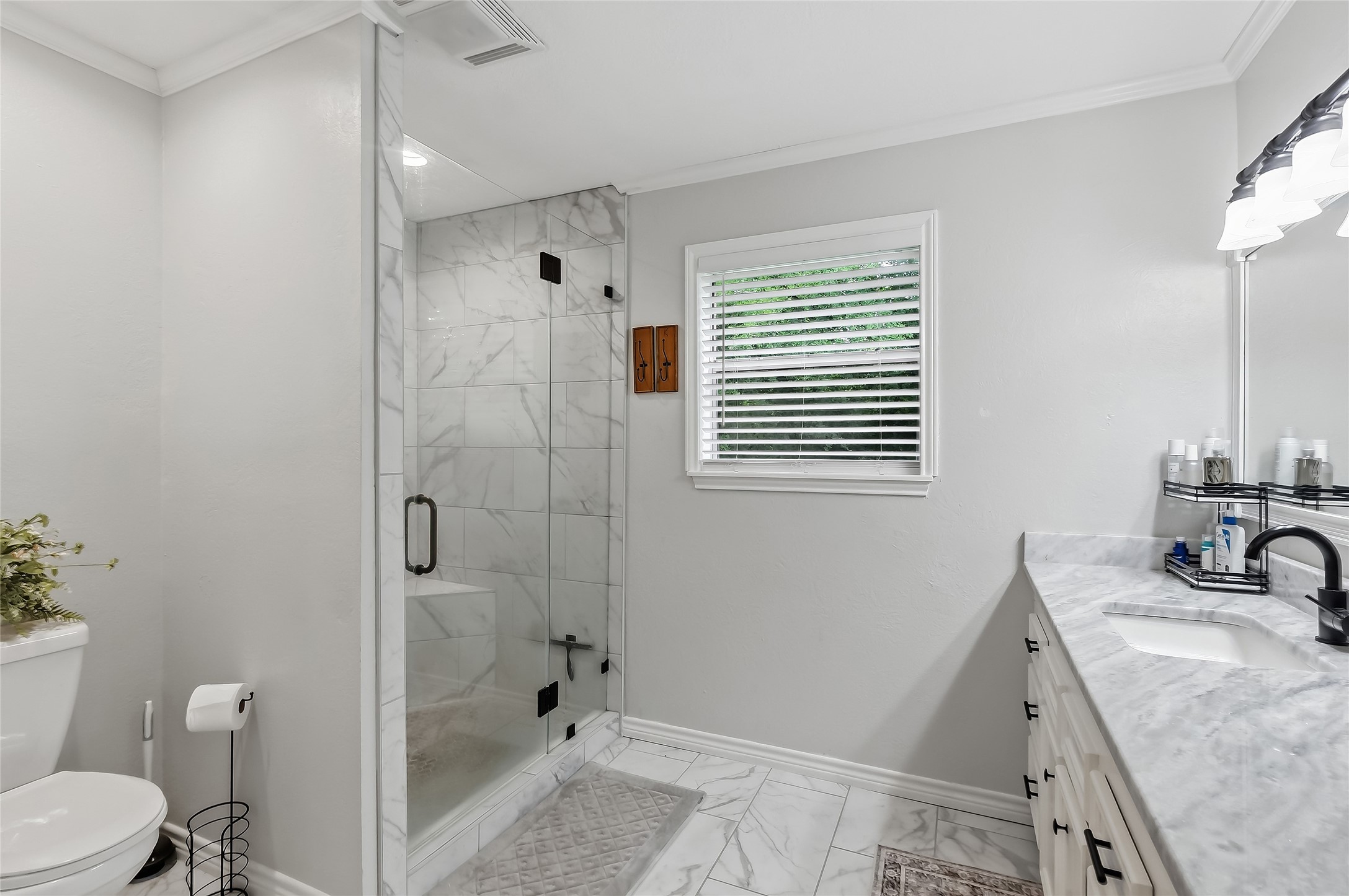 906 Standley Road Madisonville, TX 77864 - Photo 25 of 40 a bathroom with a sink a toilet and shower