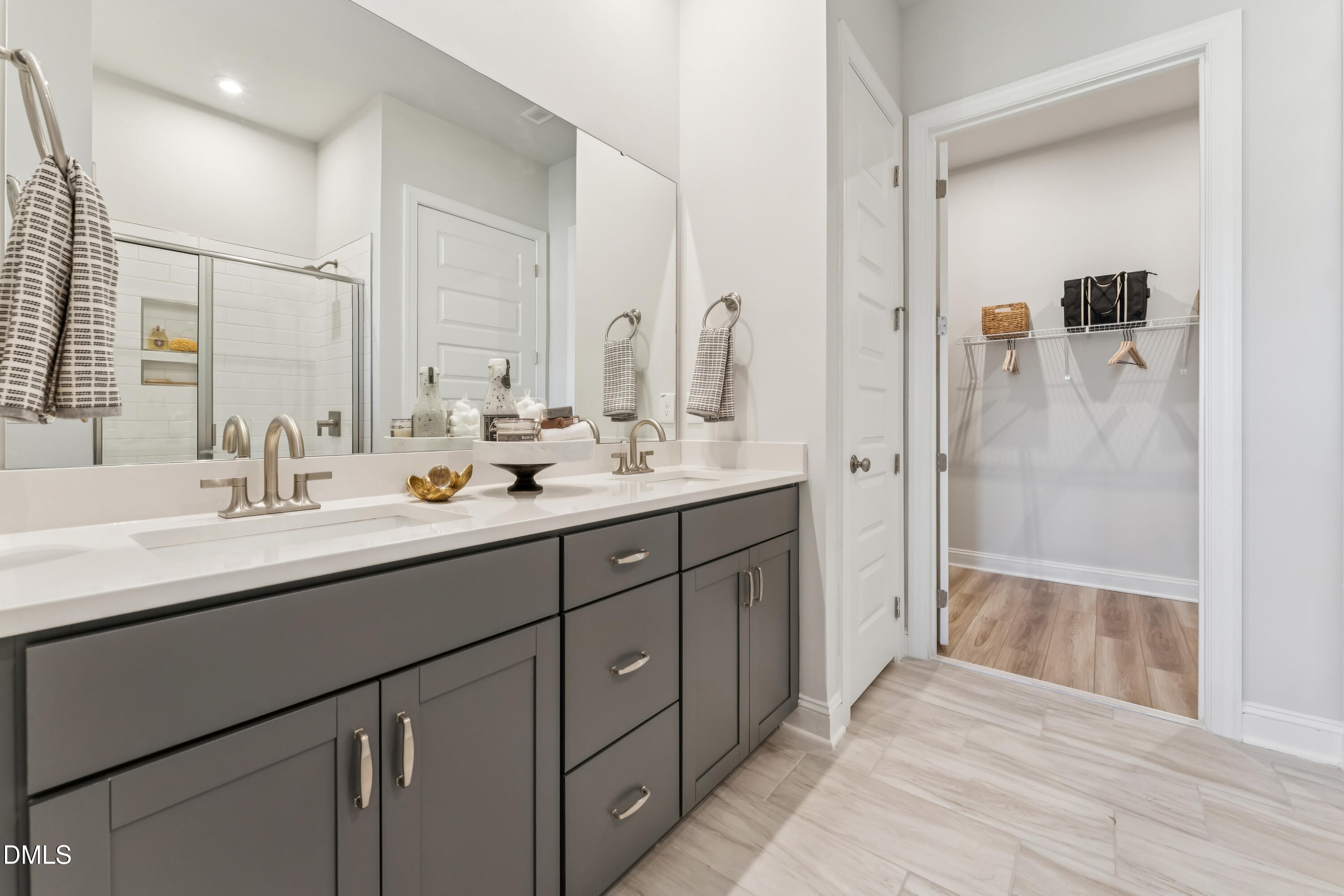 2144 Barnside Lane Apex, NC 27502 - Photo 13 of 25 a bathroom with a double vanity sink mirror double and shower