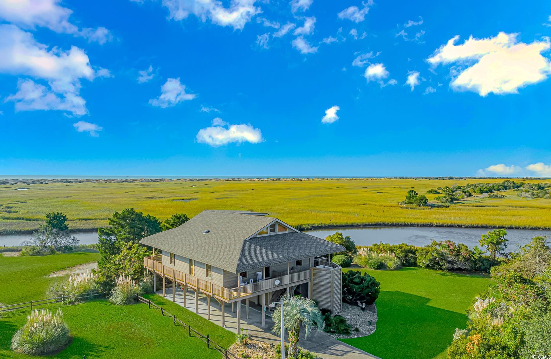 1417 Inlet Street Sunset Beach, NC 28468 - Photo 1 of 36 Aerial view with a water view and a rural view