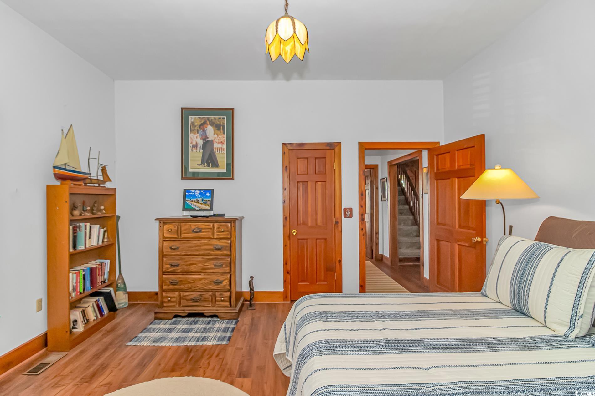 1417 Inlet Street Sunset Beach, NC 28468 - Photo 18 of 36 Bedroom featuring light hardwood / wood-style floo