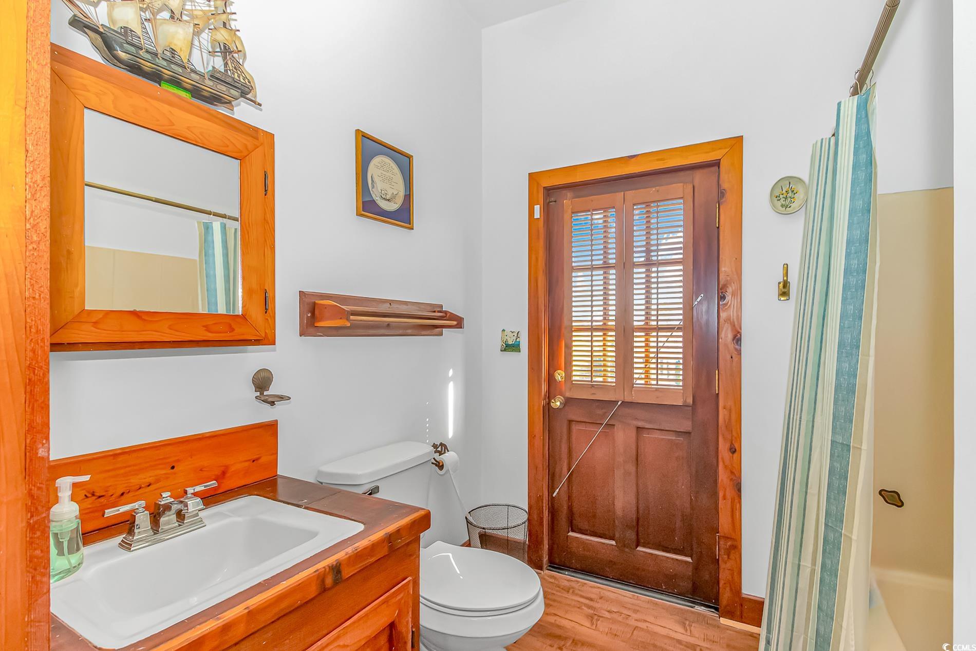 1417 Inlet Street Sunset Beach, NC 28468 - Photo 19 of 36 Bathroom with toilet, vanity, wood-type flooring,