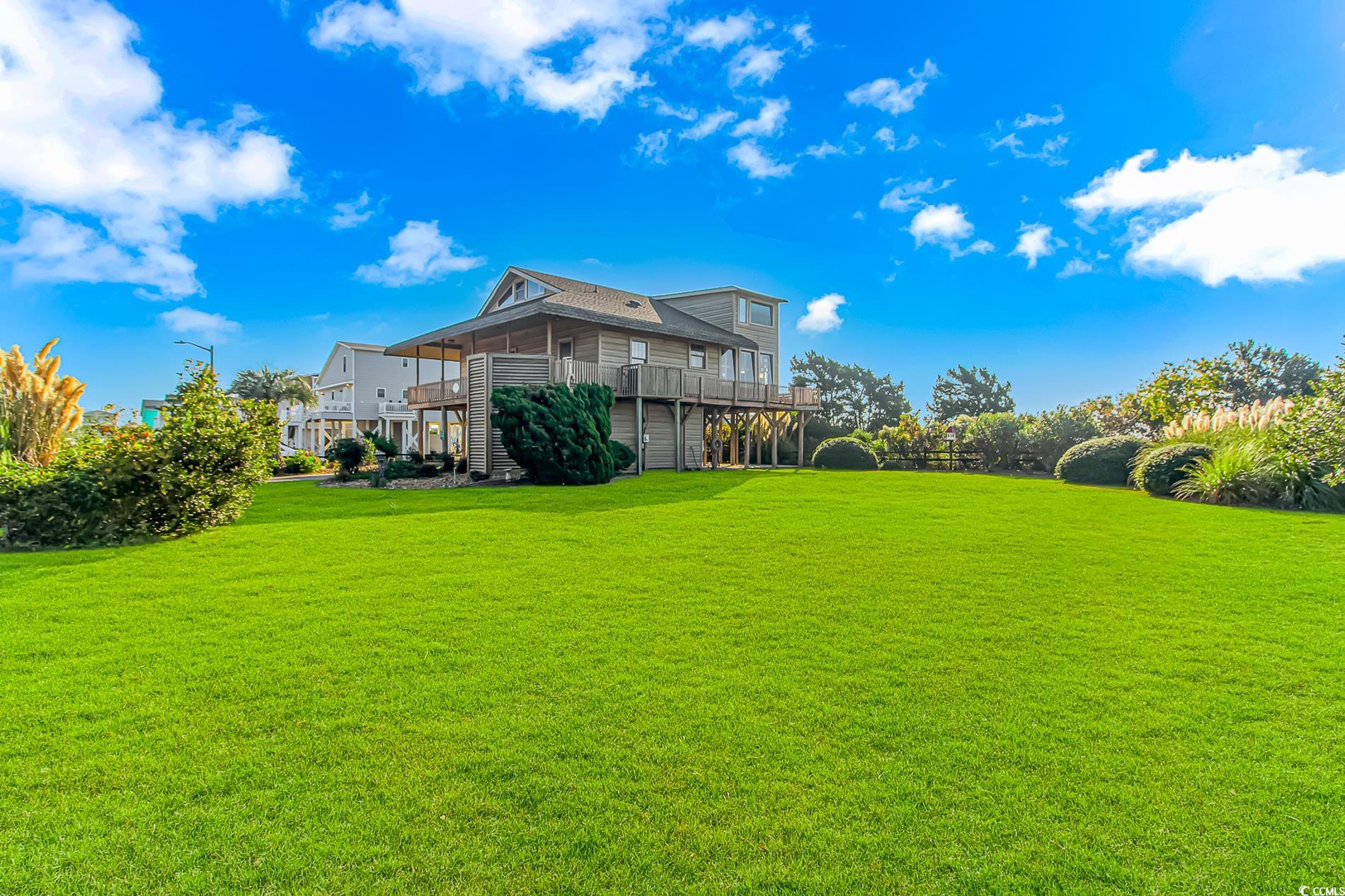 1417 Inlet Street Sunset Beach, NC 28468 - Photo 2 of 36 View of yard with a deck