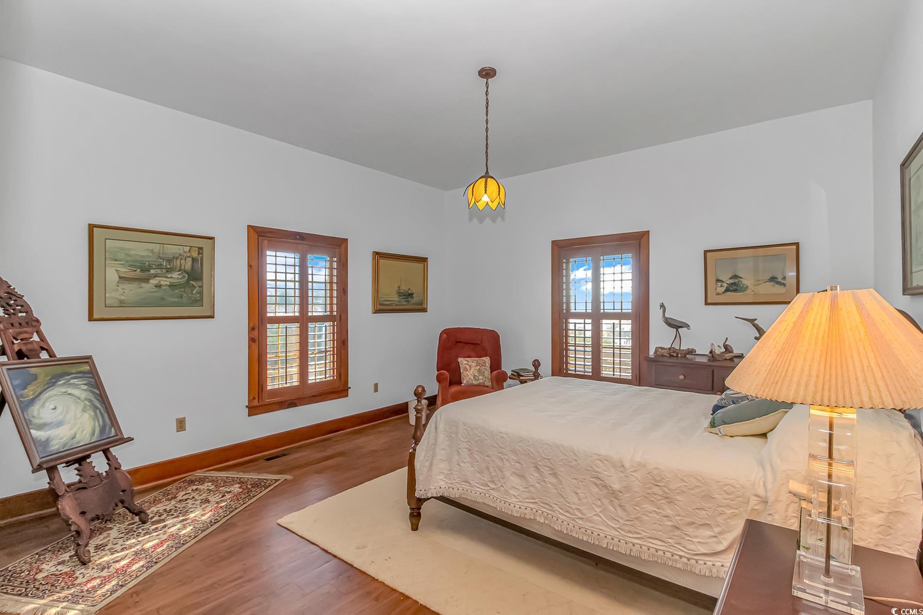 1417 Inlet Street Sunset Beach, NC 28468 - Photo 21 of 36 Bedroom with dark hardwood / wood-style floors