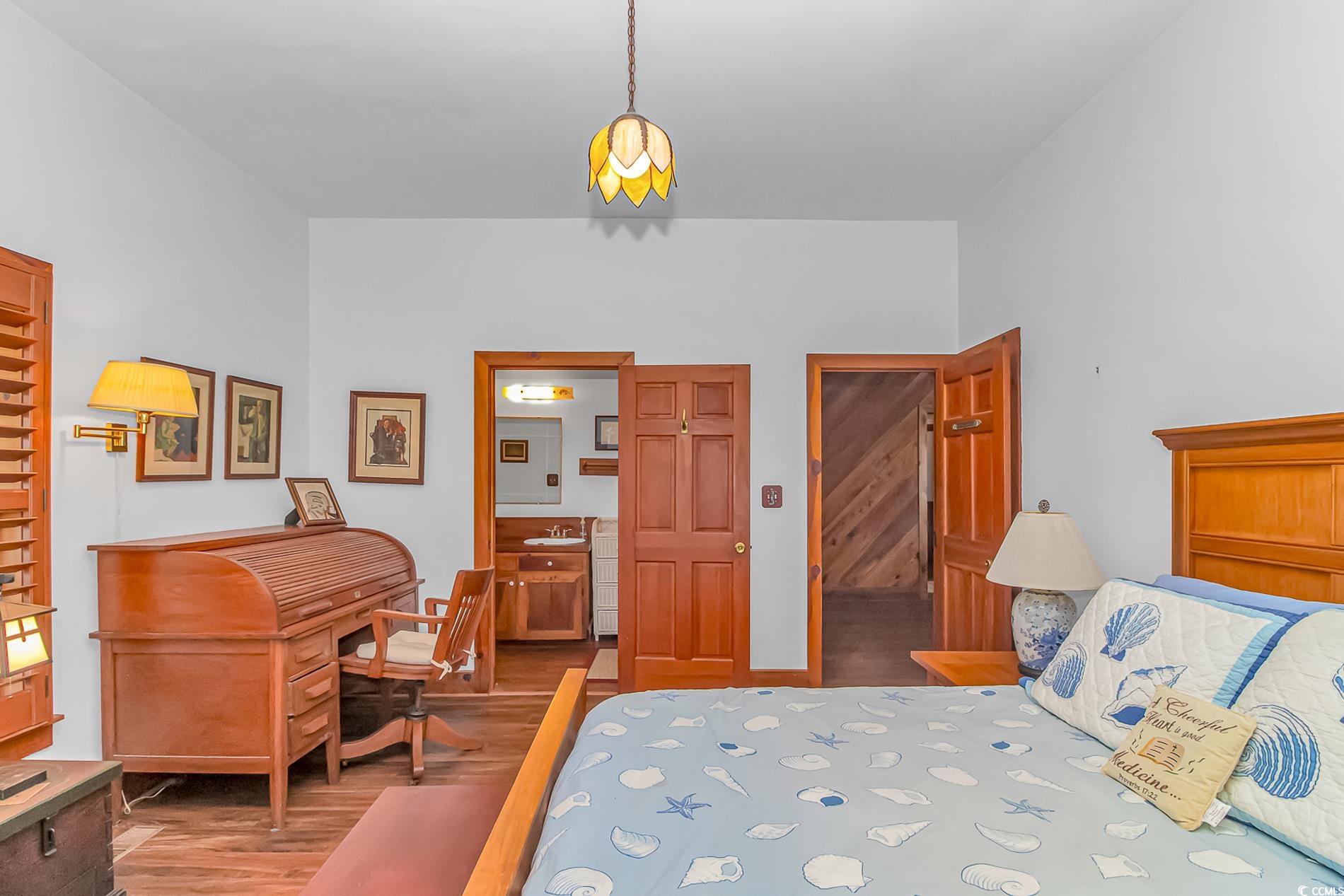 1417 Inlet Street Sunset Beach, NC 28468 - Photo 24 of 36 Bedroom featuring sink, hardwood / wood-style floo