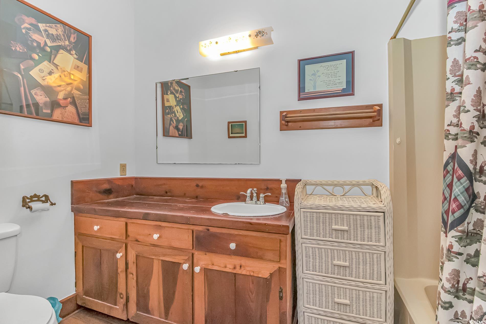 1417 Inlet Street Sunset Beach, NC 28468 - Photo 26 of 36 Full bathroom with vanity, toilet, and shower / tu