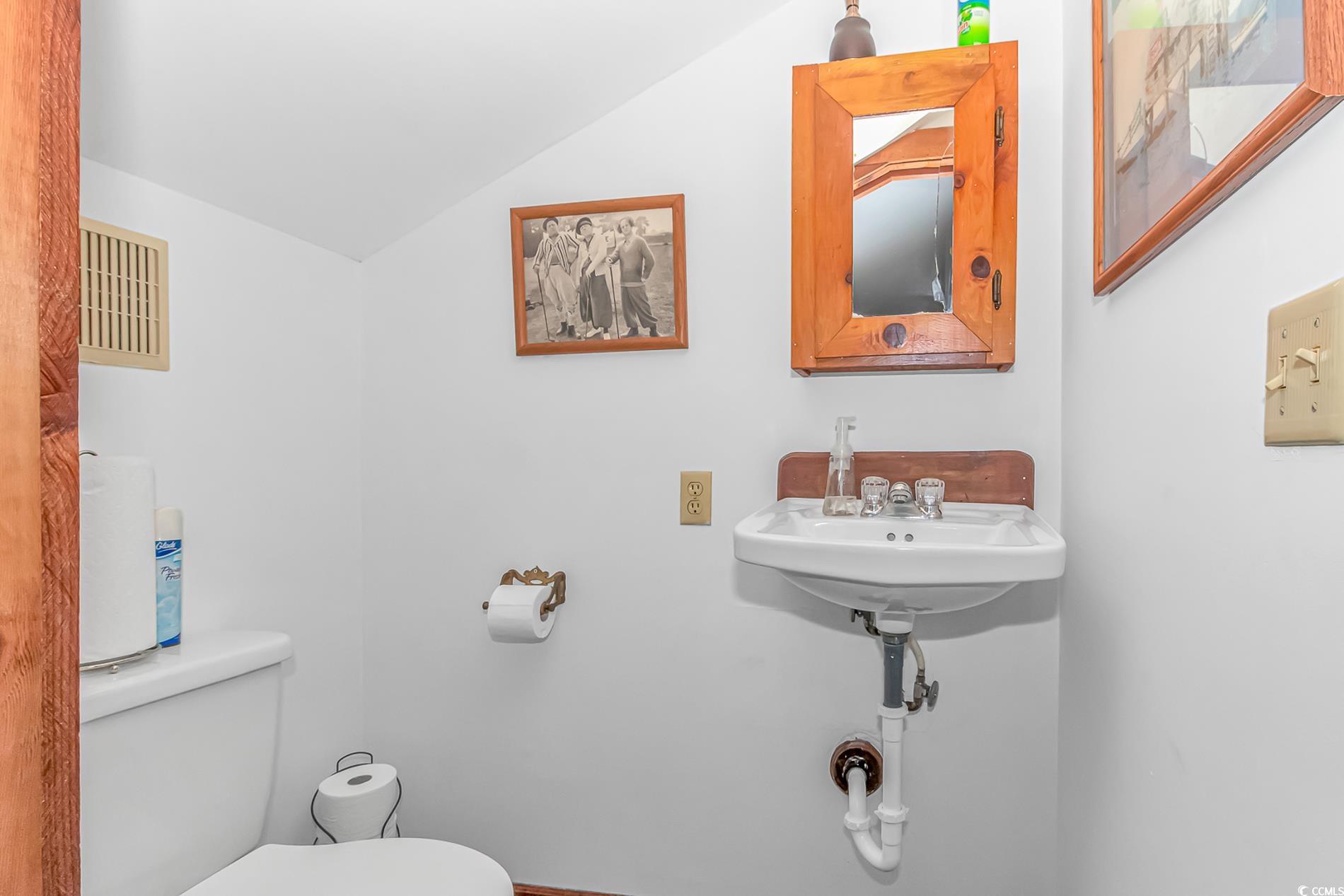 1417 Inlet Street Sunset Beach, NC 28468 - Photo 29 of 36 Bathroom with sink, toilet, and vaulted ceiling