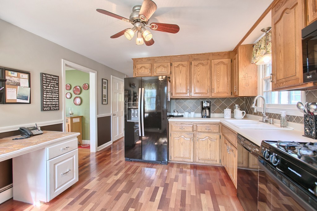 46 Charme Road Billerica, MA 01821 - Photo 11 of 30 a kitchen with stainless steel appliances granite countertop a stove top oven a sink a refrigerator cabinets and wooden floor