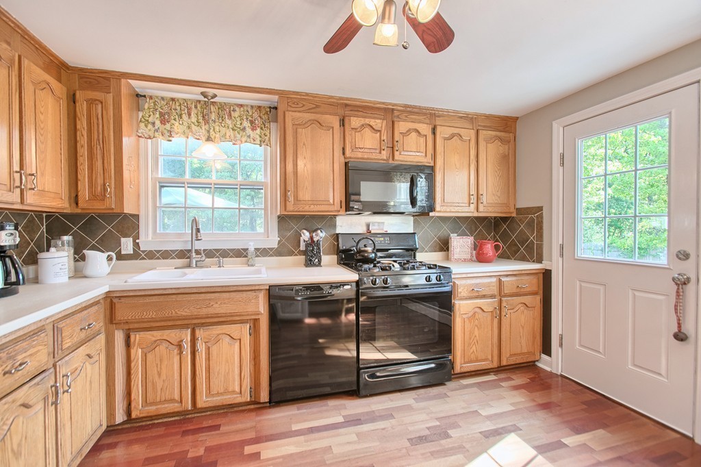 46 Charme Road Billerica, MA 01821 - Photo 13 of 30 a kitchen with kitchen island granite countertop a stove a sink and a window
