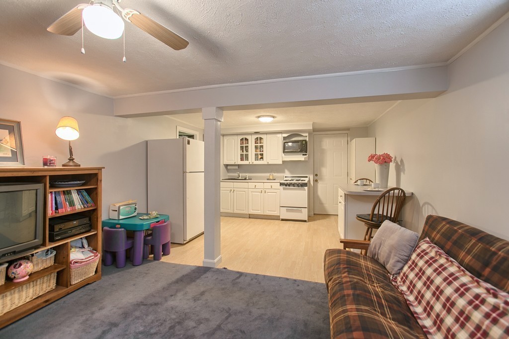 46 Charme Road Billerica, MA 01821 - Photo 27 of 30 a living room with furniture and a flat screen tv