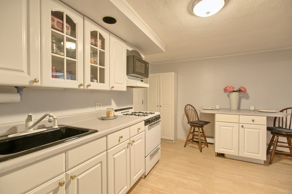46 Charme Road Billerica, MA 01821 - Photo 29 of 30 a kitchen with a sink stove and cabinets