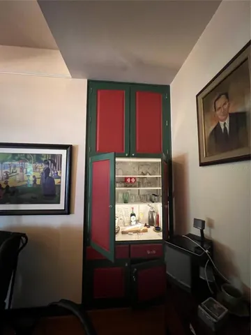 a kitchen with a sink appliances and wooden floor