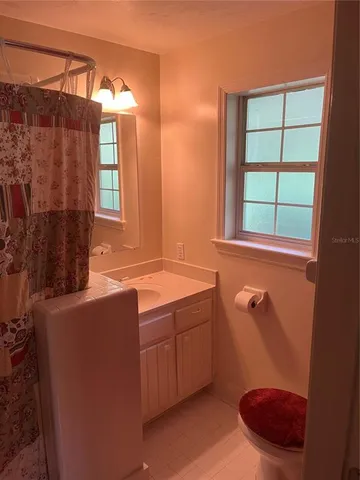 a spacious bedroom with a bed and a mirror