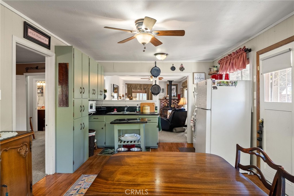 7554 Humboldt Road Butte Meadows, CA 95942 - Photo 14 of 41 a room with kitchen island a chandelier and a dining table