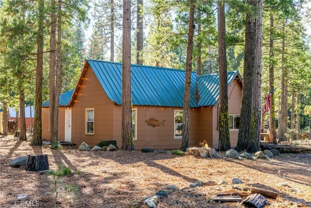 a view of house with tree in front of it