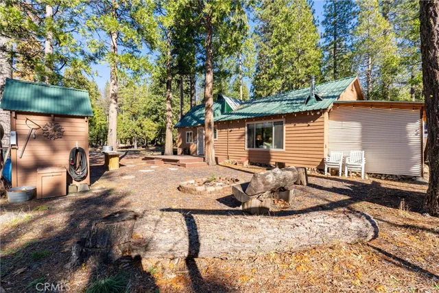 a view of a backyard with table and chairs and wooden fence