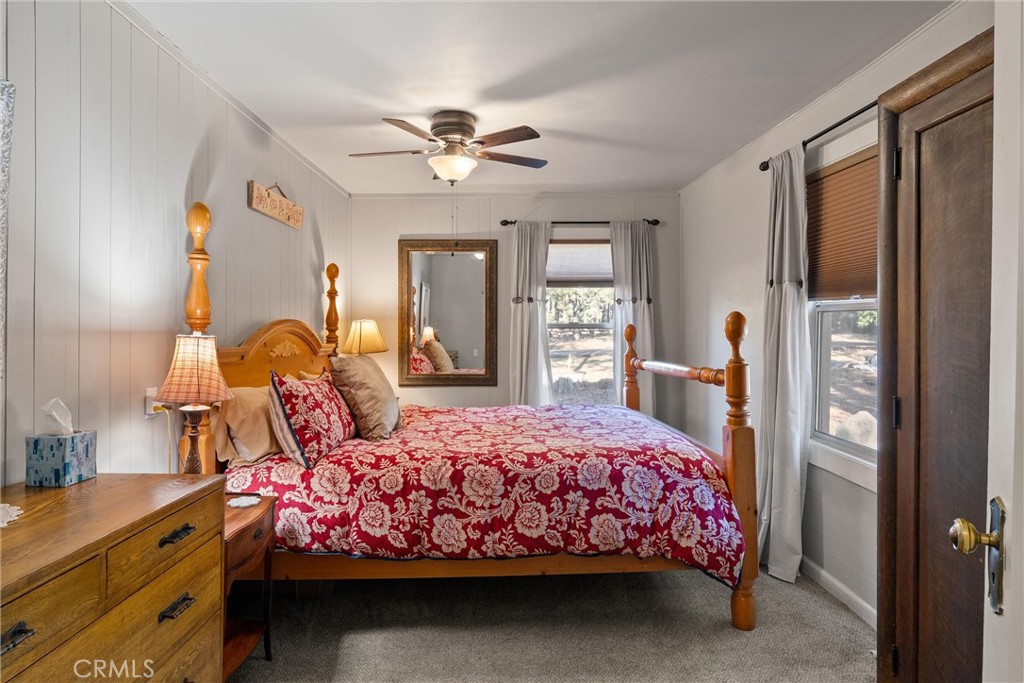 7554 Humboldt Road Butte Meadows, CA 95942 - Photo 8 of 41 a bedroom with a bed chandelier and a window