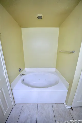 a bath tub sitting in a bathroom next to a sink