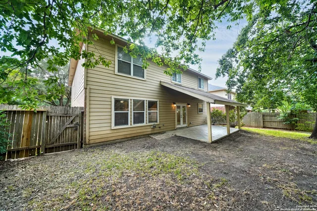 a view of a house with a yard and sitting area